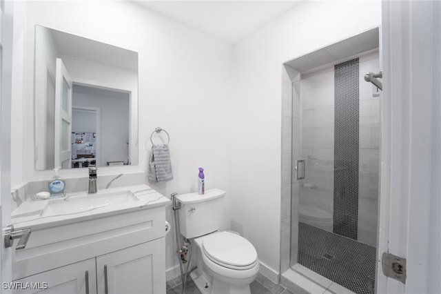 bathroom featuring tile patterned flooring, vanity, toilet, and a shower with shower door