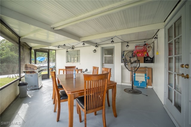 sunroom with beam ceiling and plenty of natural light