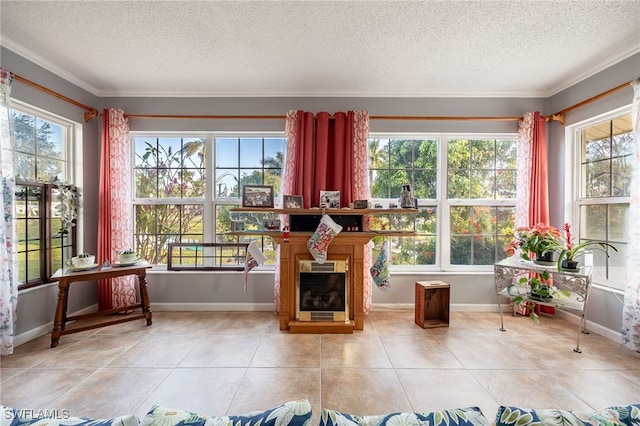 sunroom with a wealth of natural light and a glass covered fireplace