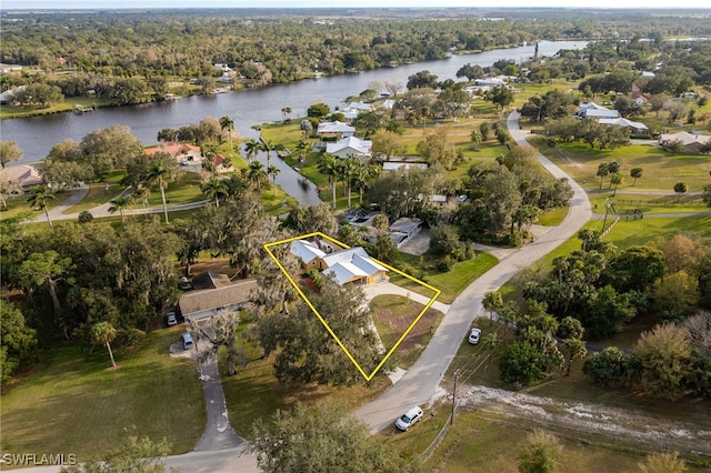 drone / aerial view featuring a forest view and a water view