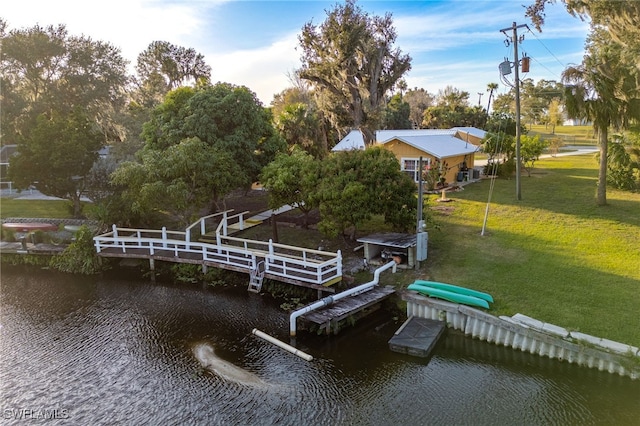 view of dock featuring a yard and a water view