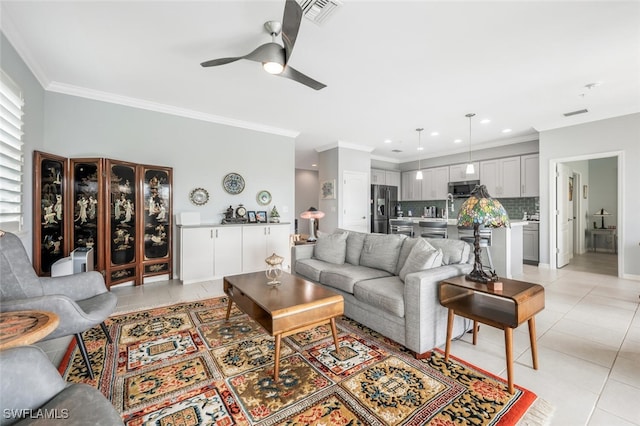 tiled living room featuring ceiling fan and ornamental molding