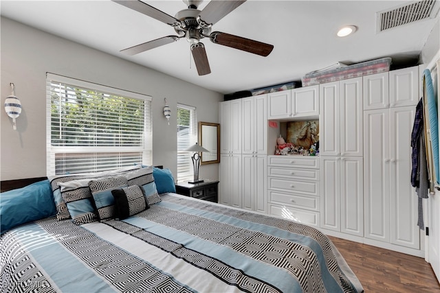 bedroom with dark hardwood / wood-style floors and ceiling fan