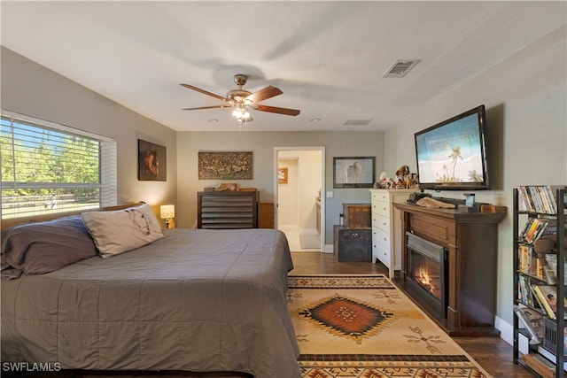 bedroom with dark hardwood / wood-style floors and ceiling fan