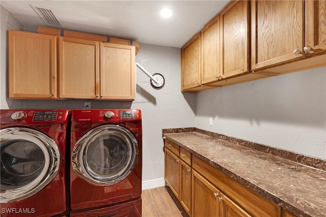 laundry area featuring cabinets and separate washer and dryer