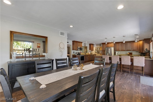 dining room with dark hardwood / wood-style floors and sink