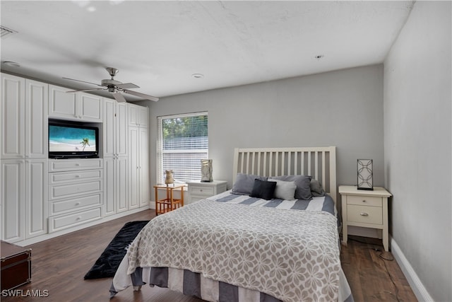 bedroom with dark hardwood / wood-style floors and ceiling fan