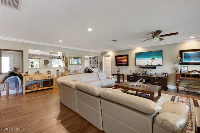 living room with crown molding, light wood-type flooring, and ceiling fan