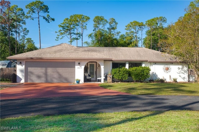 single story home featuring a garage and a front lawn