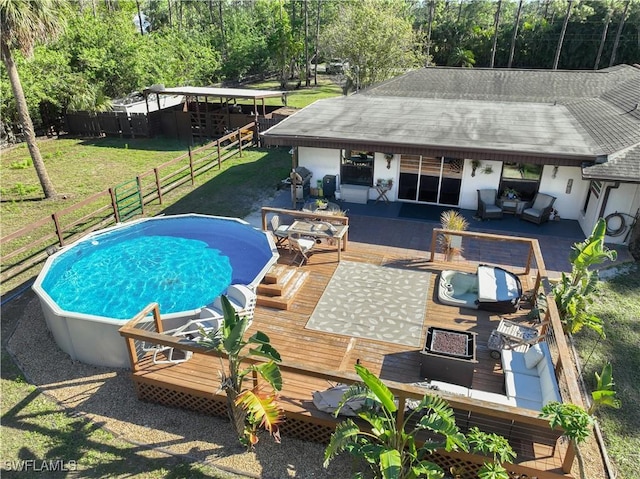 view of pool featuring a deck, an outdoor living space, and a lawn