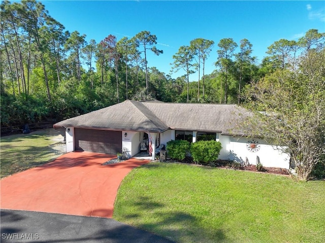 single story home featuring a garage and a front yard