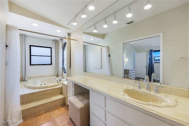 bathroom featuring vanity, tile patterned flooring, lofted ceiling, and tiled bath