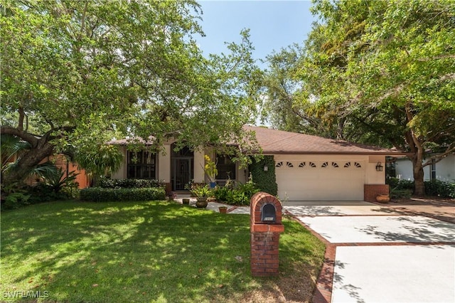 view of front of house with a front yard and a garage