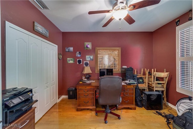 office area with light wood-type flooring and ceiling fan