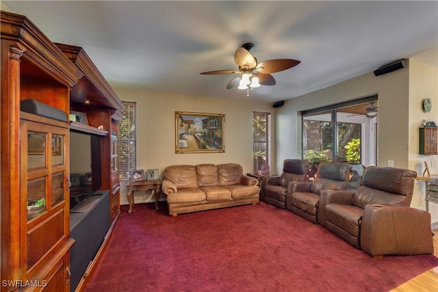 carpeted living room with ceiling fan