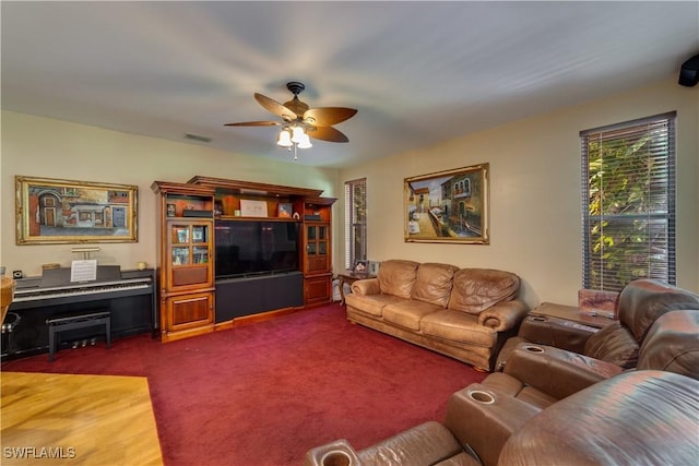 carpeted living room featuring ceiling fan