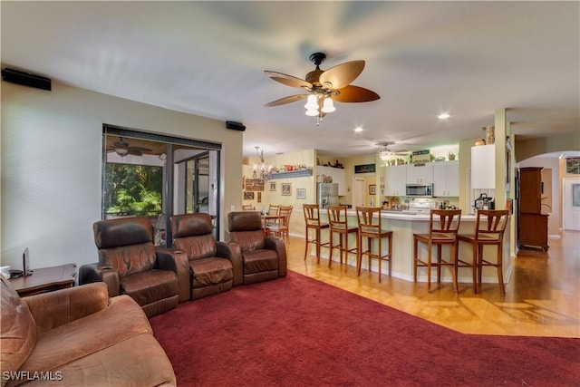 living room with light colored carpet and an inviting chandelier