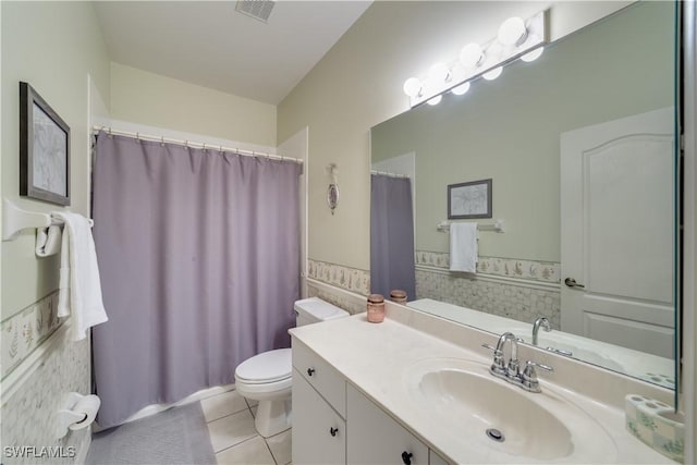 bathroom featuring tile patterned floors, vanity, and toilet