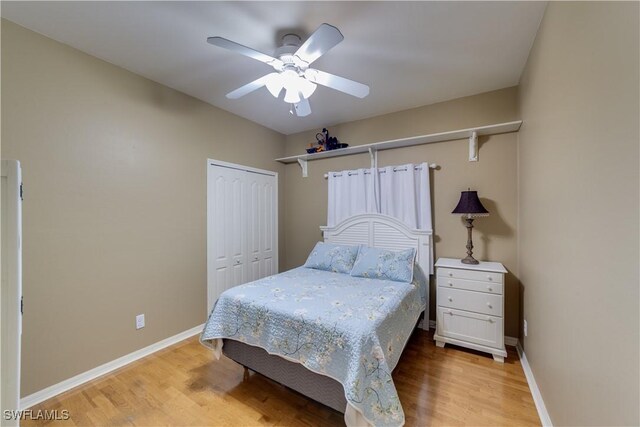 bedroom with hardwood / wood-style flooring, ceiling fan, and a closet