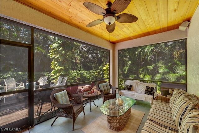 sunroom / solarium featuring a wealth of natural light, ceiling fan, and wooden ceiling