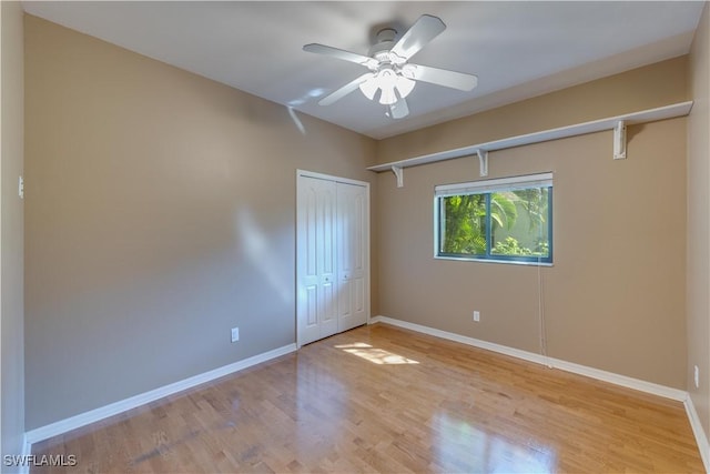 5960 Grey Fox Run, Fort Myers, FL 33912 - unfurnished bedroom with wood finished floors, baseboards, a closet, and a ceiling fan