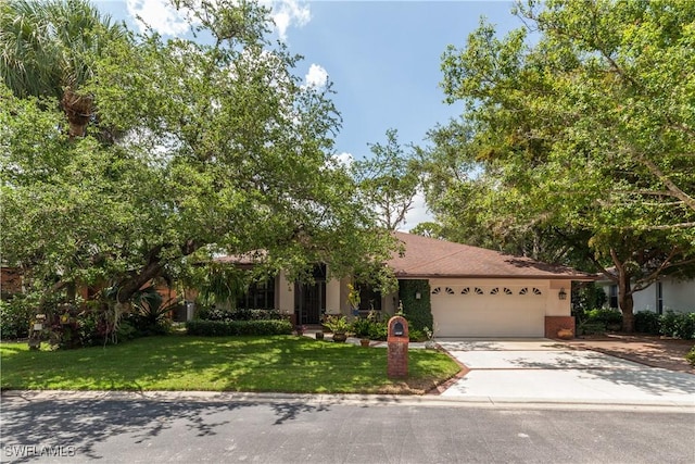 5960 Grey Fox Run, Fort Myers, FL 33912 - view of front of property with a garage, driveway, and a front lawn
