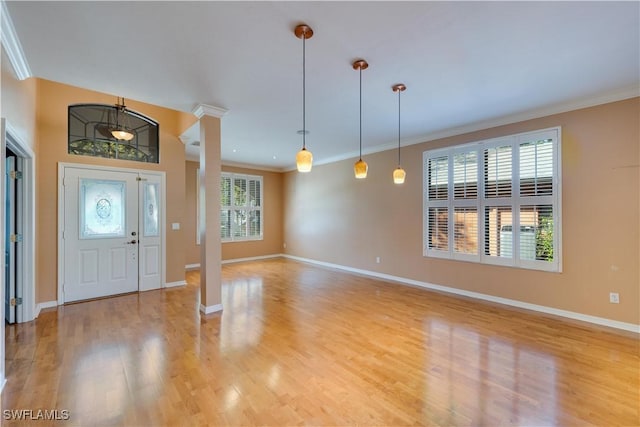 5960 Grey Fox Run, Fort Myers, FL 33912 - foyer entrance featuring crown molding, baseboards, light wood-style flooring, and ornate columns