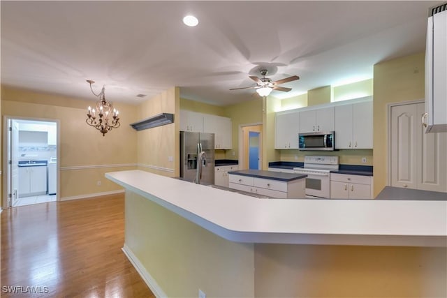 5960 Grey Fox Run, Fort Myers, FL 33912 - kitchen featuring stainless steel appliances, a chandelier, a ceiling fan, white cabinets, and light wood-type flooring