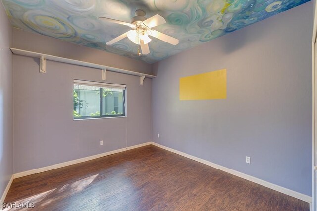5960 Grey Fox Run, Fort Myers, FL 33912 - unfurnished room with dark wood-type flooring, ceiling fan, and baseboards