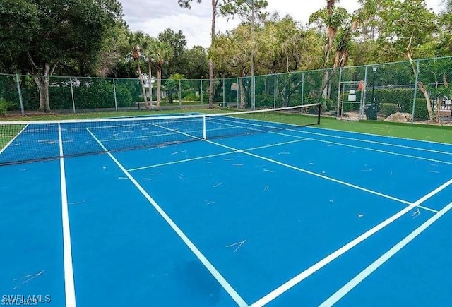 5960 Grey Fox Run, Fort Myers, FL 33912 - view of tennis court featuring view of wooded area
