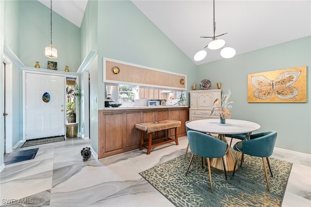 dining room featuring high vaulted ceiling