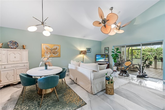 living room with ceiling fan with notable chandelier and lofted ceiling