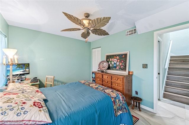 bedroom featuring ceiling fan and a closet