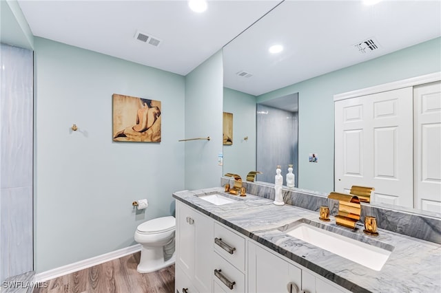 bathroom featuring vanity, hardwood / wood-style flooring, and toilet