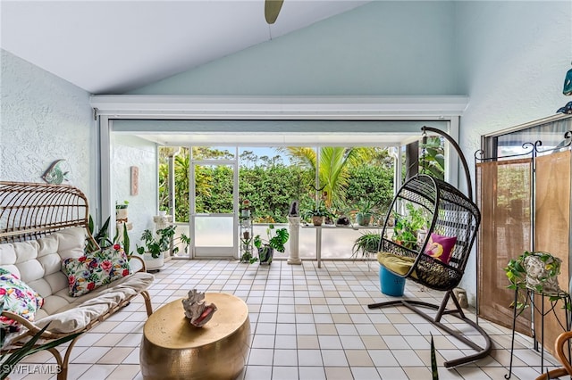 sunroom featuring ceiling fan and vaulted ceiling