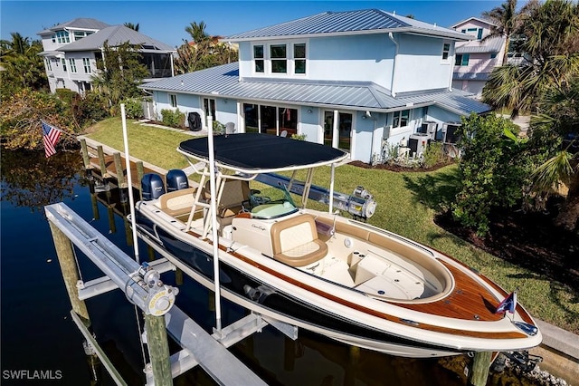 dock area with a water view and a lawn