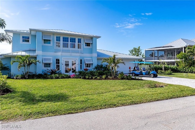 view of front of property with a front lawn and french doors