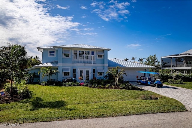 view of front of home with french doors and a front lawn