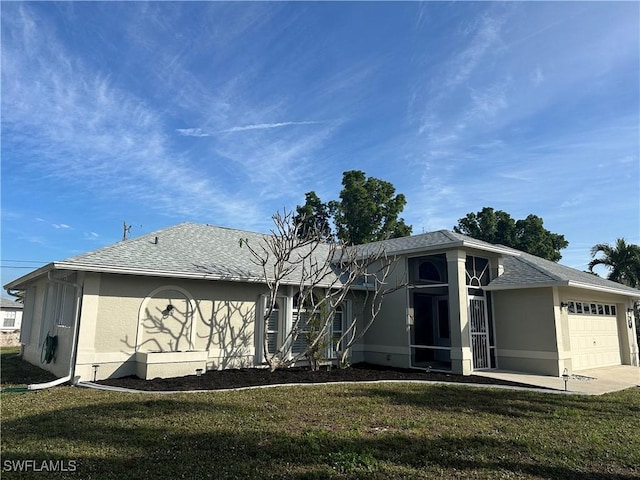 exterior space with a garage and a front lawn