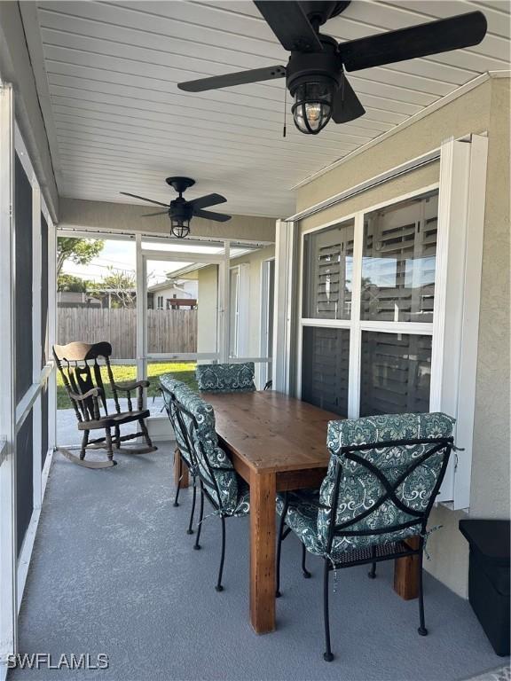 sunroom / solarium featuring ceiling fan