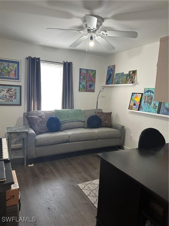 living room with dark hardwood / wood-style floors and ceiling fan