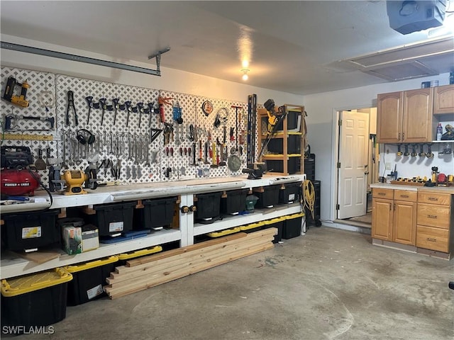 garage with a workshop area and a garage door opener