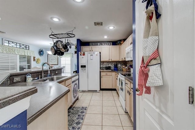 3622 NE 18th Pl, Cape Coral, FL 33909 - kitchen featuring white appliances, a sink, visible vents, washer / clothes dryer, and light tile patterned flooring