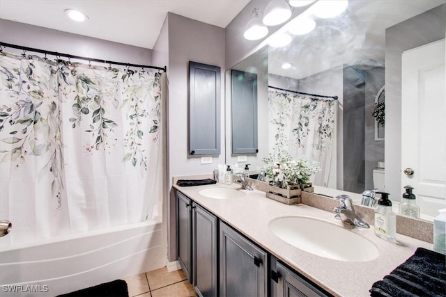 full bathroom featuring tile patterned floors, vanity, toilet, and shower / bath combo with shower curtain