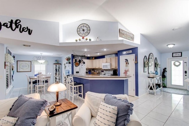 living room with light tile patterned floors and vaulted ceiling