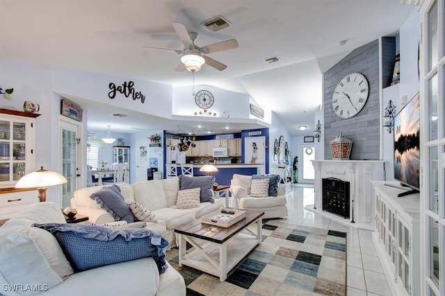 living room with ceiling fan, light tile patterned floors, and lofted ceiling