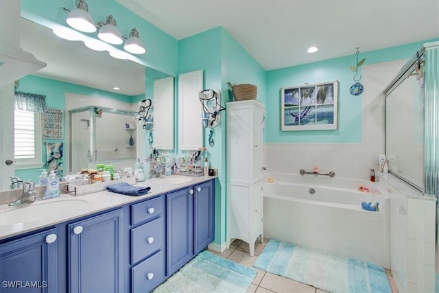 bathroom with tile patterned floors, vanity, and shower with separate bathtub