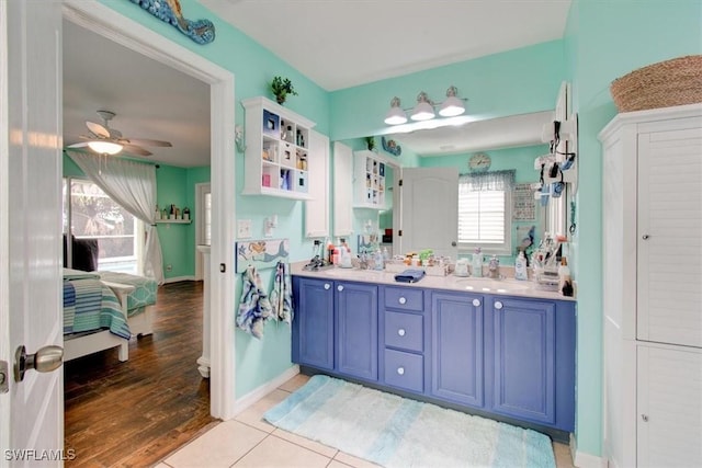 bathroom with ceiling fan, tile patterned flooring, and vanity