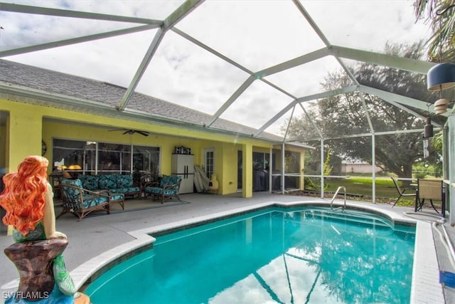 view of swimming pool featuring a lanai, ceiling fan, and a patio