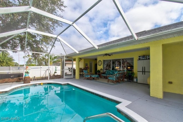 view of swimming pool featuring a lanai, an outdoor hangout area, ceiling fan, and a patio area